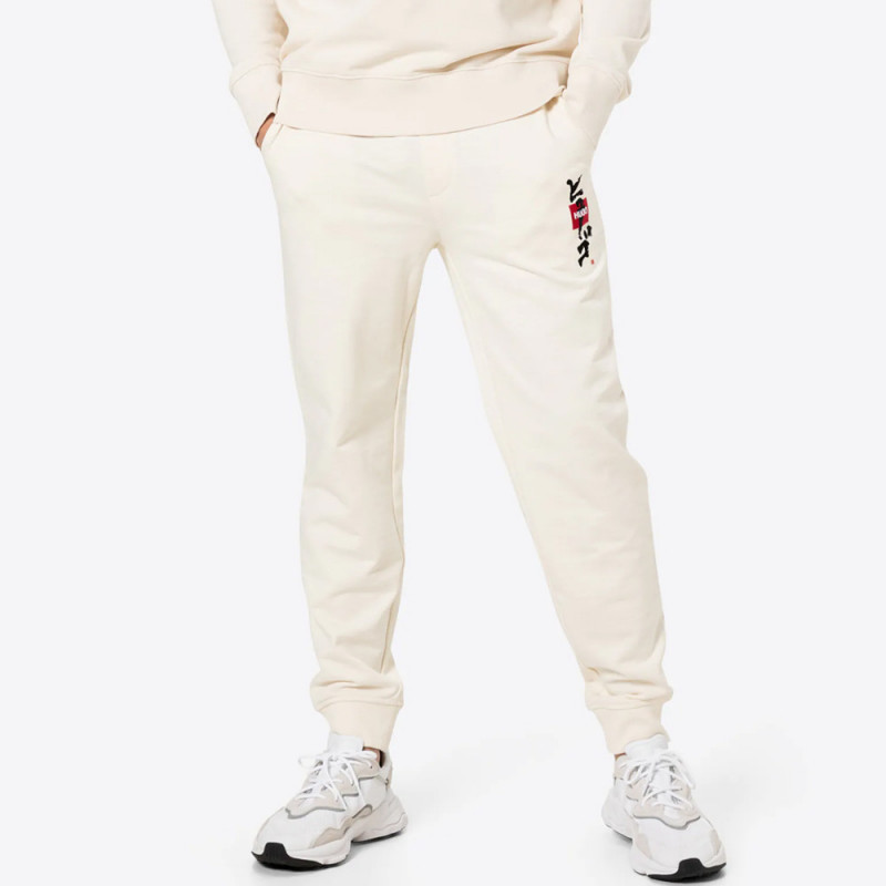 Pantalon de survêtement Dohagi beige en molleton avec logo et motif calligraphique artistique