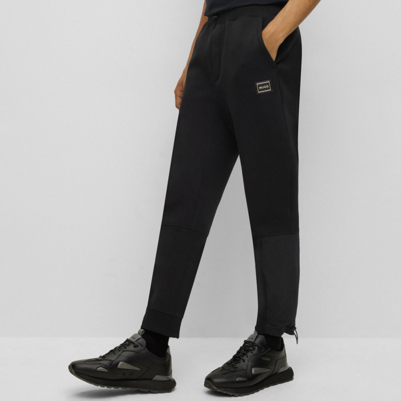 Bas de survêtement en coton mélangé avec logo encadré chez DM'Sports