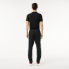 Pantalon de survêtement Lacoste SPORT avec bande Lacoste chez DMS